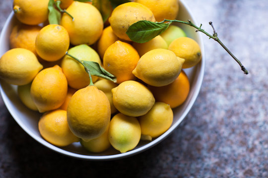 Bowl full of organic meyer lemons on the counter