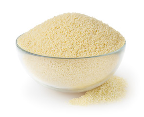 Uncooked couscous in glass bowl isolated on white background with clipping path