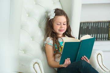 beautiful young woman with a bow on her head girl reading a book
