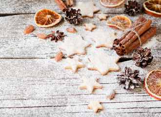 Christmas gingerbread cookies stars on a wooden table and cookie cutters, selective focus