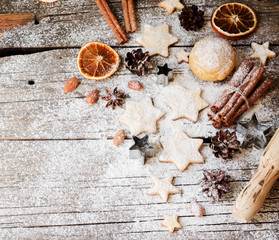 Christmas gingerbread cookies stars on a wooden table and cookie cutters, selective focus