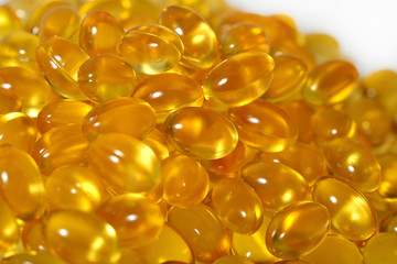 Omega-3 fish fat oil capsules as background texture