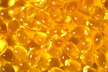 Omega-3 fish fat oil capsules as background texture