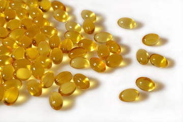 Omega-3 fish fat oil capsules close up on a white background.