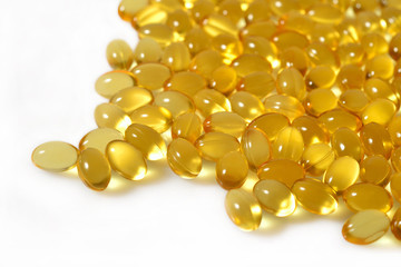 Fototapeta premium Omega-3 fish fat oil capsules close up on a white background.