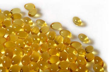 Omega-3 fish fat oil capsules close up on a white background.
