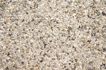 Tiny gravel texture on brown concrete wall texture background.