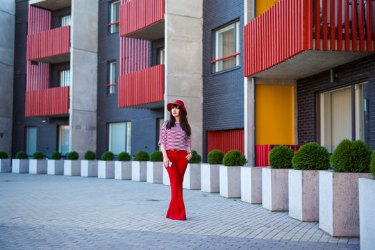 Young Woman In Red Walking On The Street