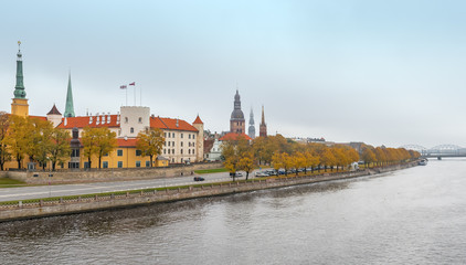 Obraz premium Waterfront of Daugava river and medieval part of old Riga at misty morning. Riga is the capital of Latvia and famous tourist site in Baltic region of Europe