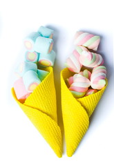 Colorful foam candy in ice cream cones