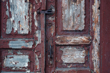 Old red painted textured grungy wooden door