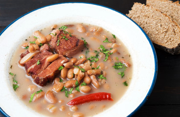 Boiled beans with meat on a plate