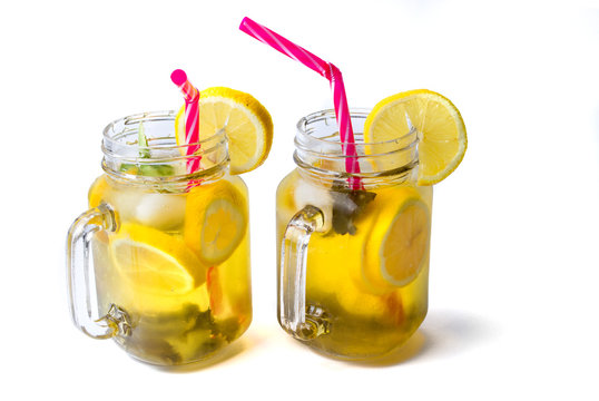 Lemon juice with mint leafs in glass jars