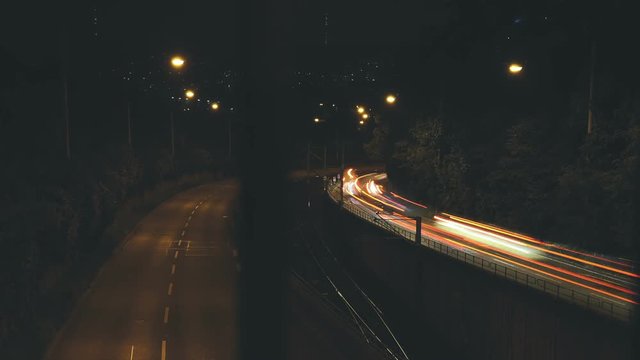 Stuttgart highway traffic at night from a bridge. A dynamic display of lights and motion. Time lapse.