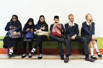 Group of diverse students using mobile phones