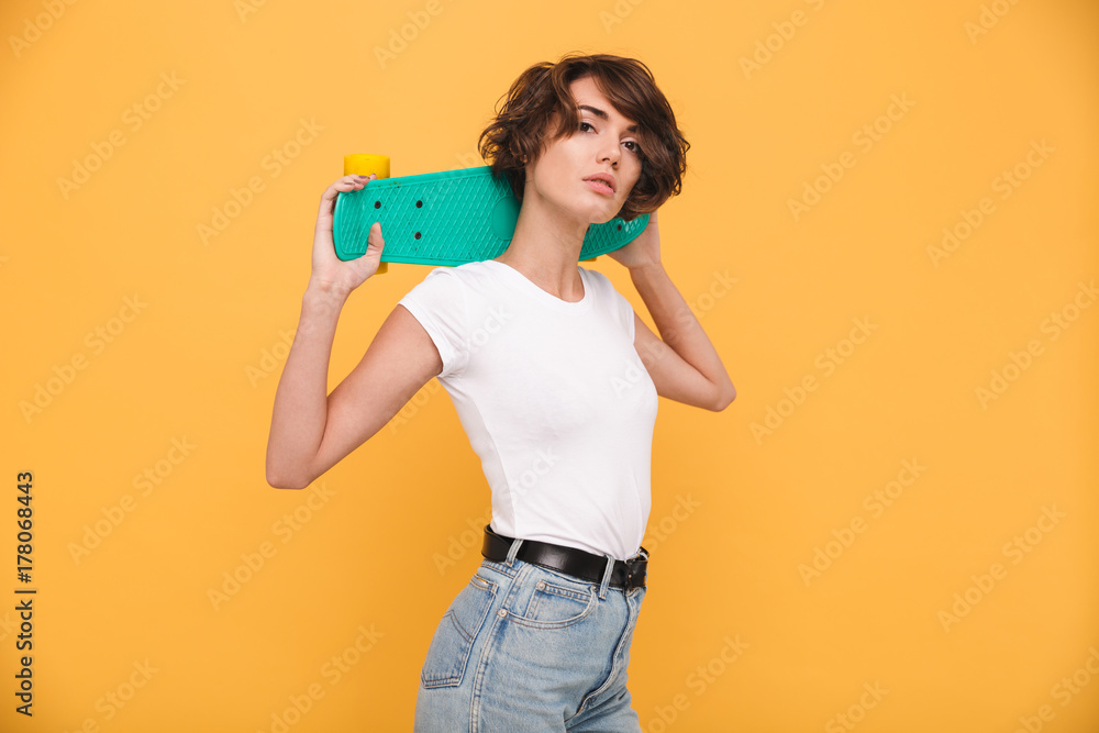 Sticker Portrait of an attractive young girl holding skateboard