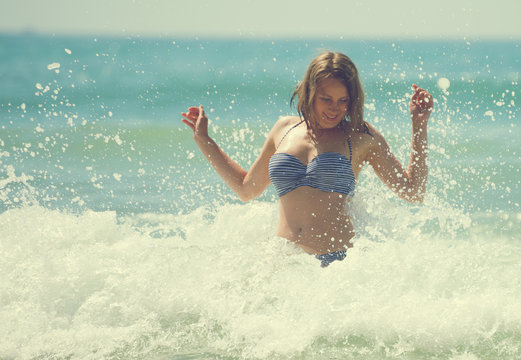 Happy woman having fun in the sea.