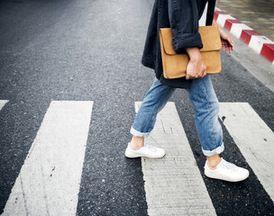 Person walking across the pedestrian lane - obrazy, fototapety, plakaty
