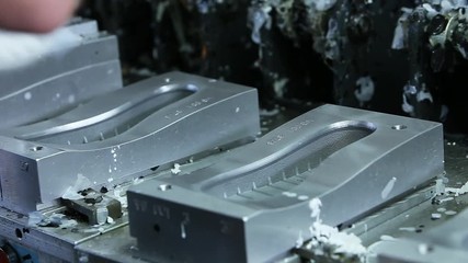 Close up view of hands pull out the rubber soles from the molding shoe soles.