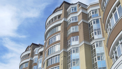 Fototapeta premium Modern, Luxury Apartment Building. Luxury residential house with concrete pathway over front yard. Part of the house blu sky background