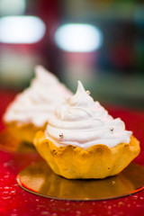 two swirling cakes on a red table