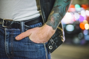 Tattooed man with hand in pocket