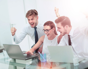 Business team celebrating a triumph with arms up