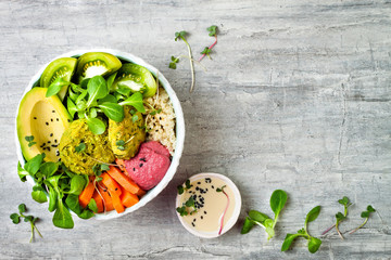 Middle eastern style Buddha bowl with green falafel, quinoa, butternut squash, tomatoes, avocado,...
