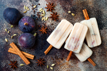 Masala chai latte popsicles with figs on cinnamon sticks. Spiced ice lollies for fall and winter...