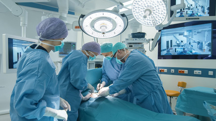 Medical Team Performing Surgical Operation in Bright Modern Operating Room