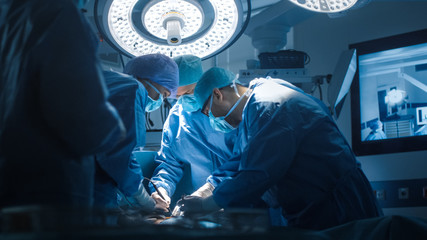 Close up Shot of Medical Team Performing Surgical Operation in Modern Operating Room