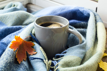 still life a cup of coffee and autumn leaves with plaid