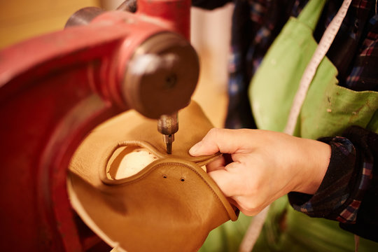 Shoemaker making leather shoes
