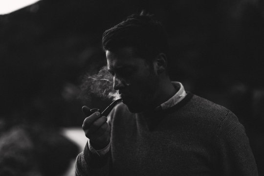 young man smoking pipe