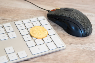 Golden bitcoin on a keyboard