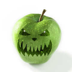 Halloween mask on a green apple