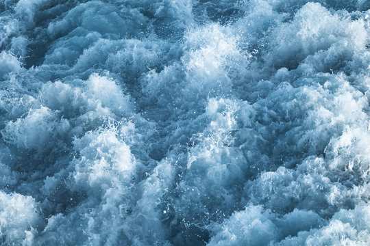 Dark blue stormy ocean water with splashes © evannovostro