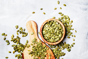 Raw pumpkin seeds, food background, top view