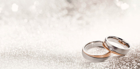 Designer wedding rings on a sparkling background