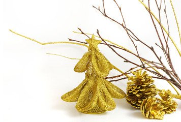 Golden Christmas decor includes glittery tree, bare twigs and pinecones with copy space on white background
