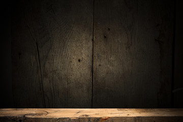 Wooden deck table on green grunge background