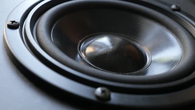 Slow pan over acoustic diaphragm close-up footage - Modern high fidelity speaker membrane vibrations