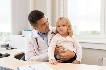 doctor or pediatrician with girl patient at clinic