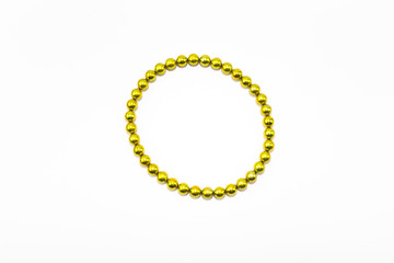 Yellow bracelet made of magnet on white background