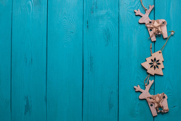Turquoise background for Christmas cards. Background for Christmas wishes. Blue wooden planks. Vintage background for congratulation. Christmas card. Holiday gift. Christmas deer.