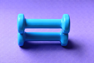 Shaping and fitness equipment. Dumbbells in cyan blue color