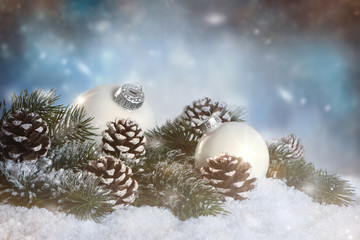 Fototapeta na wymiar Christmasdecoration in white with snow on blurry backround