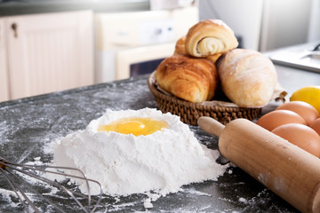 Woman's hands knead dough with flour, eggs and ingredients. at kitchen.
