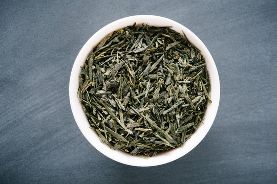 Bowl of Loose Green Sencha Tea Presented on a Black Chalkboard Surface
