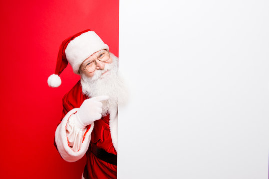 Advertisement, discounts, presents gifts selling december, winter tradition wish, eve, celebration of christmastime concept. Santa is standing near the white blank banner and points at side, empty